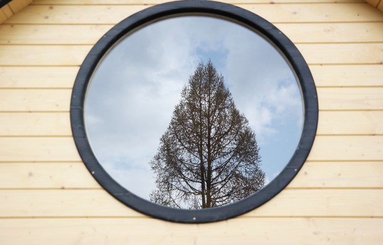 Sauna barrel with side entrance Round window in sauna room