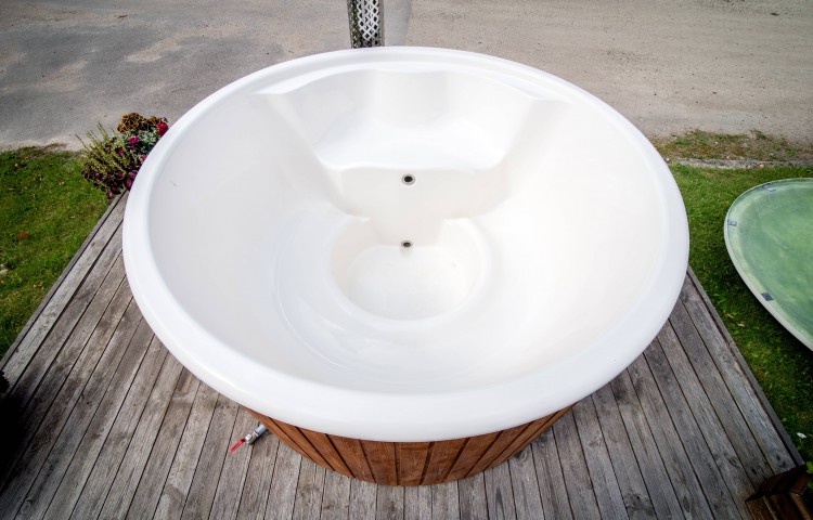 Fiberglass hot tub with integrated heater